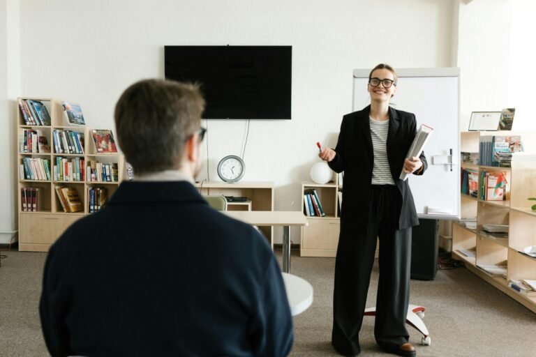 Businesswoman giving presentation in office with bookshelves and clock.