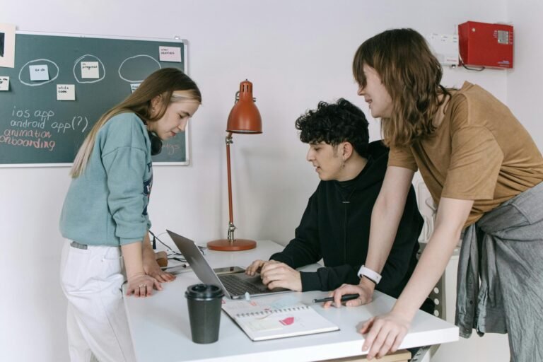 Group of young developers brainstorming ideas for a tech startup in a modern office setting.