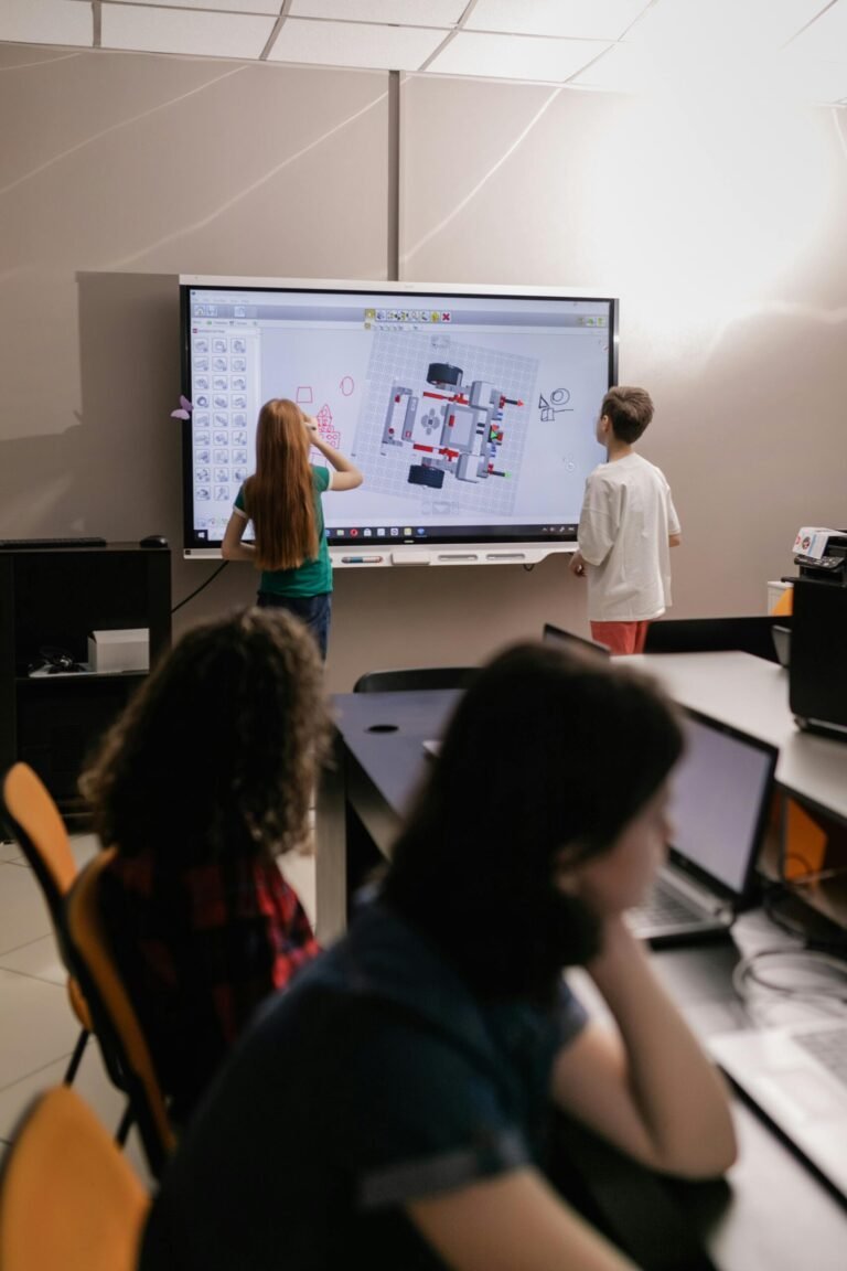 Kids learning with an interactive board in a modern classroom setting.