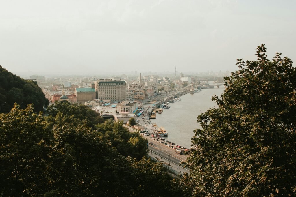 Aerial view of Kyiv's scenic skyline and waterfront on a foggy morning.